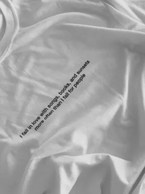 I fall in love with songs, books and sunsets more often than I fall for people T-Shirt (white)